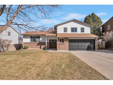 Charming two-story home featuring brick and siding, a driveway, and well-maintained front lawn at 3733 W 97Th Ave, Westminster, CO 80031