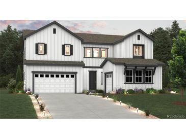 Inviting two-story home featuring white siding, a two-car garage, and a well-manicured lawn at 2548 Lupton Ln, Lafayette, CO 80026
