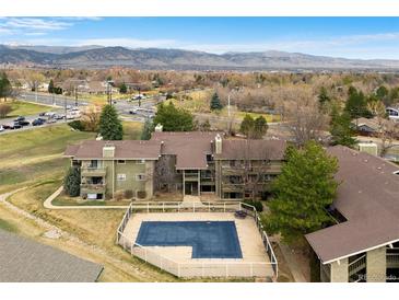 Aerial view of a condo complex with a pool, landscaping, and mountain views at 695 Manhattan Dr # 5, Boulder, CO 80303