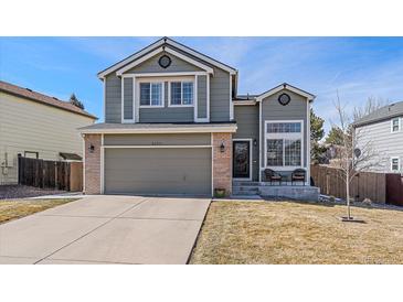 Charming two-story home with a well-maintained lawn and attached two-car garage at 5253 S Jericho St, Centennial, CO 80015