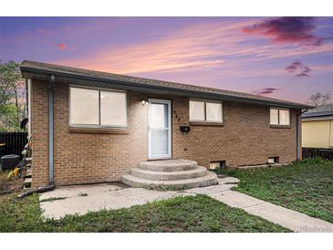 Charming single story brick home with a well-maintained front yard and concrete steps to the front door at 547 S 3Rd Avenue, Brighton, CO 80601