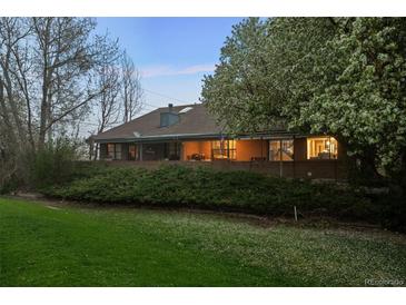 Expansive brick home with beautiful lawn, mature trees, and covered patio at 15220 E Caley Ave, Centennial, CO 80016