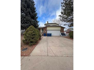 Charming two-story home features brick accents, an attached two-car garage, and a well-maintained front yard at 14989 E Pacific Pl, Aurora, CO 80014