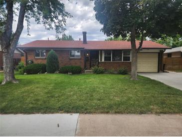 Charming brick home with a well-manicured lawn and mature trees at 6961 E Arkansas Ave, Denver, CO 80224