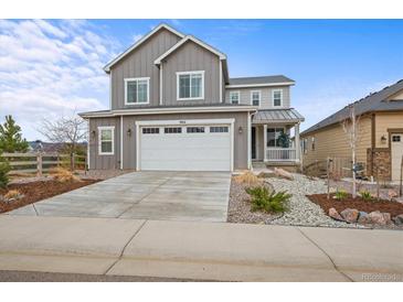 Charming two-story home with a two car garage and landscaped front yard at 9021 Swan River St, Littleton, CO 80125