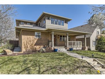 Charming brick home with a welcoming front porch and well-maintained lawn at 2692 N Raleigh St, Denver, CO 80212