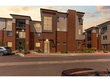 Modern condo with brick facade and multiple balconies in a convenient neighborhood setting at 14301 E Tennessee Ave # 109, Aurora, CO 80012