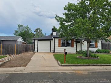 Charming single-Gathering home featuring a well-maintained front yard and attached one car garage at 2294 W Parkhill Ave, Littleton, CO 80120