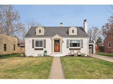 Charming home featuring a well-manicured lawn, a brick exterior, dormer windows, and an inviting front entrance at 2830 Forest St, Denver, CO 80207