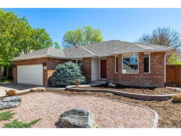 Charming single-story brick home featuring a well-manicured front yard and a two-car garage at 2072 Skylark Ct, Longmont, CO 80503