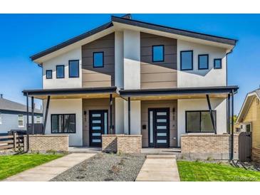 Modern duplex featuring a symmetric facade, covered entry, brick accents, and contemporary design elements at 960 Quitman St, Denver, CO 80204