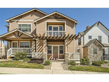 Inviting two-story home with a charming front porch and well-maintained landscaping at 5624 Killdeer St, Brighton, CO 80601