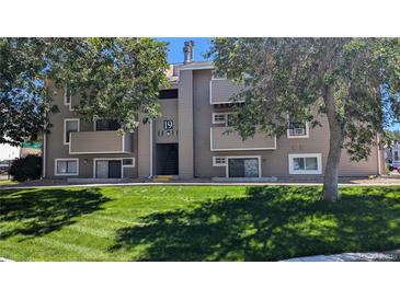 Exterior shot of building with number 19 in the center, and large trees framing the sides of the building at 10150 E Virginia Ave # 308, Denver, CO 80247