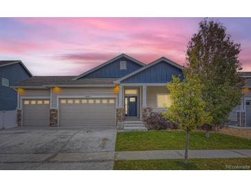 Two-story house with blue and beige siding, two-car garage, and landscaping at 2420 Nicholson St, Berthoud, CO 80513