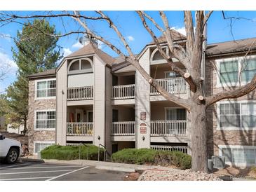 Charming condo exterior with multiple balconies and well-maintained landscaping on a sunny day at 9212 E Arbor Cir # E, Englewood, CO 80111