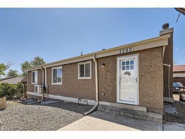 Cozy one-story home featuring a stucco exterior, front door, and well-maintained landscaping at 2060 W Iliff Ave, Englewood, CO 80110