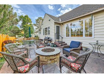 Relaxing backyard patio featuring a fire pit with outdoor seating, ideal for entertaining guests at 4505 S Yosemite St # 102, Denver, CO 80237