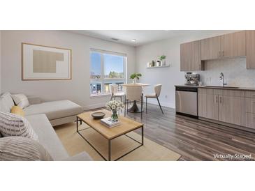 Bright living room featuring modern finishes, a dining area with city views, and stylish furniture at 2374 S University Blvd # 503, Denver, CO 80210