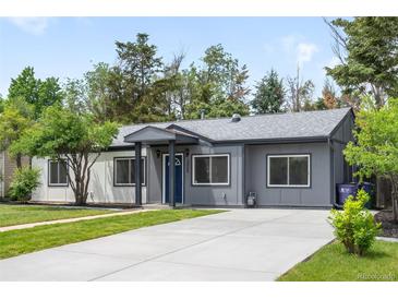 Charming single-story home featuring a well-maintained lawn and a long driveway at 3065 S Eudora St, Denver, CO 80222