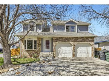 Charming two-story home with a brick facade, dormer windows and a two car garage at 3803 Dyanna Dr, Thornton, CO 80241
