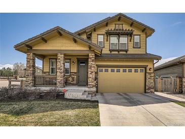 Charming two-story home with stone accents, a covered porch, and a two-car garage at 10178 Nadine Ave, Parker, CO 80134
