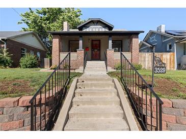 Charming brick home featuring an inviting front porch, manicured lawn, and a welcoming entrance at 3529 N Garfield St, Denver, CO 80205