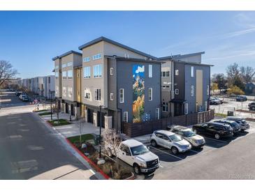 Modern townhome exterior featuring contemporary design, a mountain mural and convenient parking at 5227 N Eliot St, Denver, CO 80221