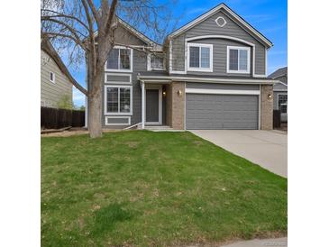 Charming two-story home with well-manicured lawn, gray siding, stone accents, and attached two car garage at 510 Fairhaven St, Castle Rock, CO 80104