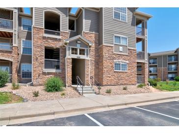 Beautiful condo complex exterior featuring stone accents and well-maintained landscaping at 1425 Blue Sky Cir # 15-107, Erie, CO 80516