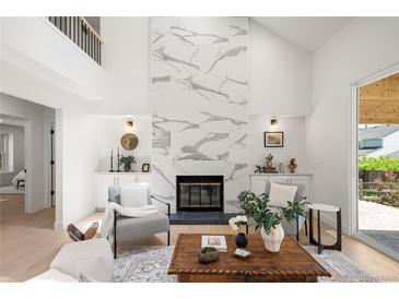 Bright living room boasts a modern fireplace, built-in cabinets, and lots of natural light at 5944 E Irwin Pl, Centennial, CO 80112