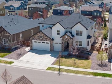 Beautiful two-story home showcasing a three-car garage and a well-maintained, landscaped front yard at 228 Horizon Ave, Erie, CO 80516