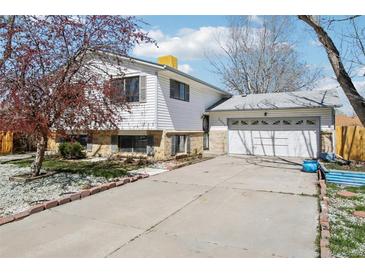 Charming two-story home with a two-car garage and a well-maintained front yard at 2633 Mather St, Brighton, CO 80601