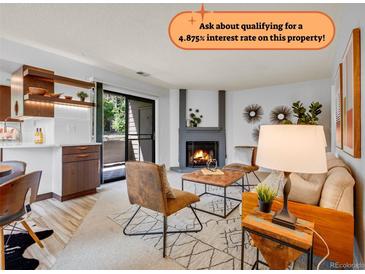 Cozy living room features a fireplace, comfortable seating, and natural light, creating an inviting space at 8378 S Upham Way # A102, Littleton, CO 80128