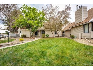 Well-maintained townhouse with manicured lawn and mature trees in a quiet, suburban neighborhood at 2459 S Xanadu Way # B, Aurora, CO 80014