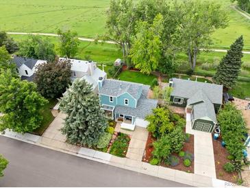 Bright two-story home with lush landscaping, mature trees, and a two-car garage at 236 W Sycamore Ln, Louisville, CO 80027