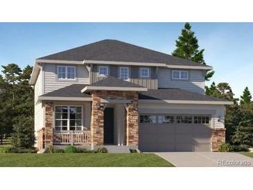 Charming two-story home featuring a two-car garage and a welcoming front porch at 687 Raindance St, Erie, CO 80516
