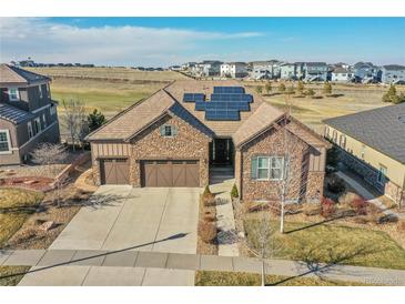 Beautiful stone home with solar panels and a three-car garage in a well-kept neighborhood at 27655 E Moraine Dr, Aurora, CO 80016