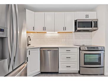 Modern kitchen featuring stainless steel appliances and white shaker cabinets at 165 S Sable Blvd # R14, Aurora, CO 80012
