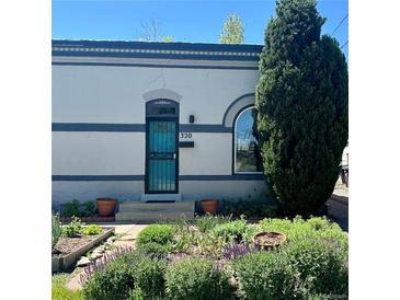 Charming home featuring a well-kept front garden and a turquoise-colored security door at 320 E Dakota Ave, Denver, CO 80209