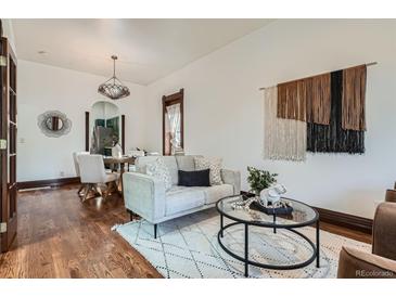 Cozy living room features hardwood floors, modern decor, and a seamless transition to the dining area at 320 E Dakota Ave, Denver, CO 80209