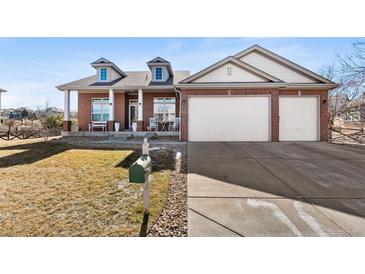 Charming brick home with a three-car garage, dormers, covered porch and well-maintained lawn at 3900 W 111Th Ave, Westminster, CO 80031