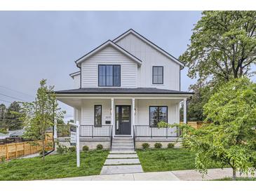 Charming two-story home featuring a covered front porch and manicured lawn, a welcoming facade at 3019 Chase St, Wheat Ridge, CO 80214