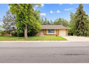 Charming single-story brick home with mature shade trees and an attached one car garage at 13493 E Dakota Ave, Aurora, CO 80012