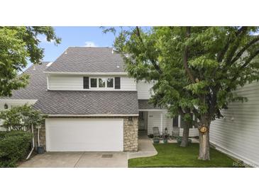Charming two-story home with a well-maintained lawn, stone accents, and a two-car garage at 4505 S Yosemite St # 433, Denver, CO 80237