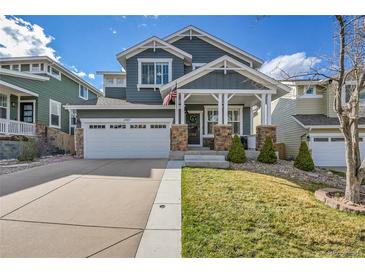 Charming two-story home featuring a manicured front yard and an attached two-car garage at 2889 Windridge Cir, Highlands Ranch, CO 80126