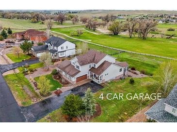 Sprawling home featuring a 4-car garage and views of green pastures and mature trees at 42225 Kingsmill Cir, Elizabeth, CO 80107