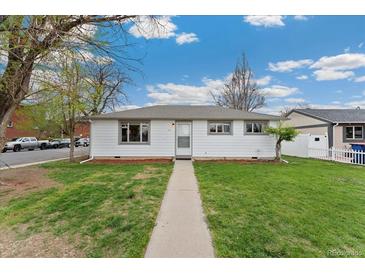 Charming single-story home with a well-maintained lawn and inviting walkway under a bright blue, partly cloudy sky at 701 Emporia St, Aurora, CO 80010