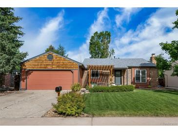 Charming home showcasing a well-manicured lawn and beautiful landscaping, perfect for outdoor enjoyment at 17372 E Prentice Cir, Centennial, CO 80015