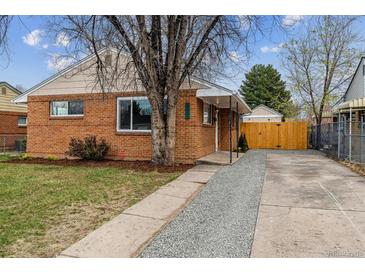Charming brick home featuring a well-maintained yard and inviting entrance at 3550 Fairfax St, Denver, CO 80207