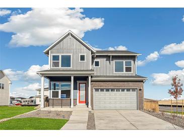 Attractive two-story home with a brick facade and a well-manicured lawn at 21295 E 61St Dr, Aurora, CO 80019